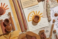 a table with various items on it, including a wooden spoon, a wooden bowl, and a wooden utensil